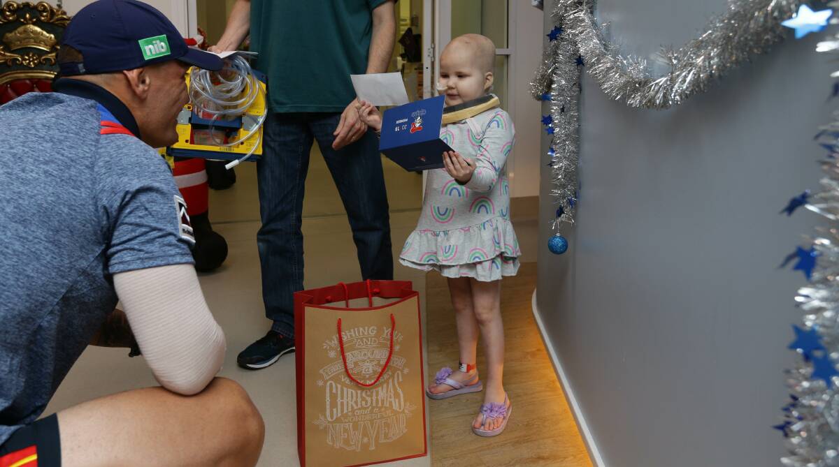 ALL SMILES: Emily Jade Pietrowiec inspects her gifts from the Knights. 