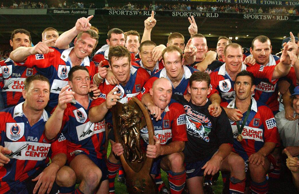 HOW SWEET IT IS: Newcastle players with the spoils of victory after the 2001 grand final.