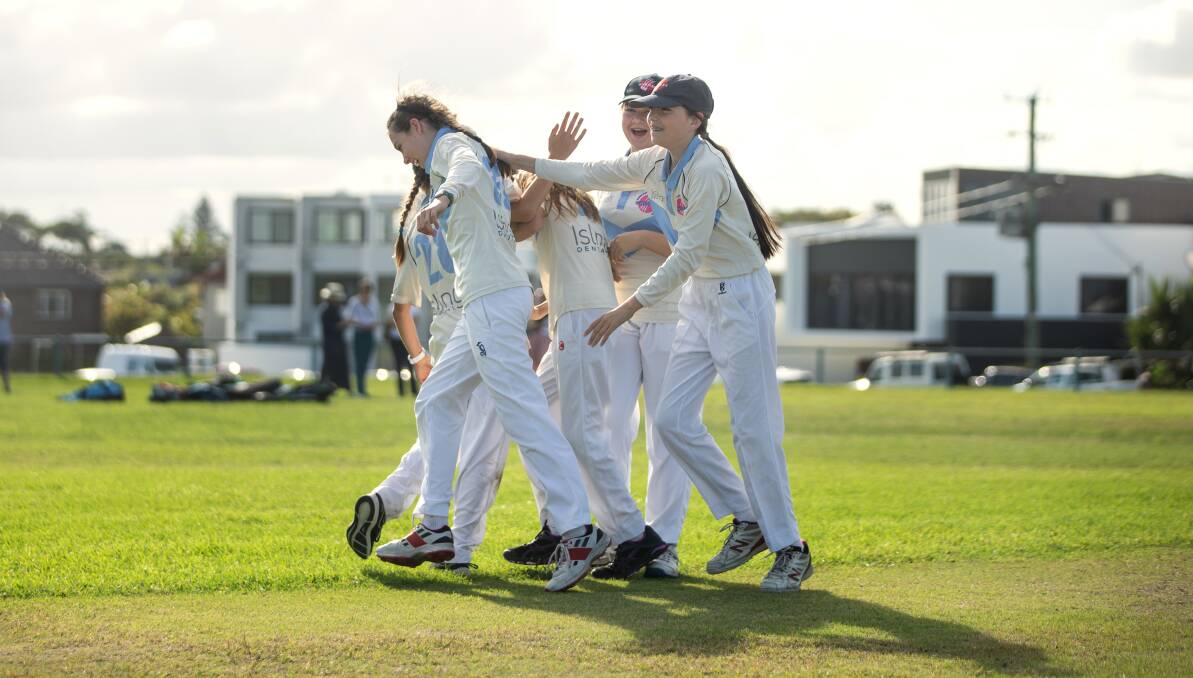 BOWLED OVER: Newcastle City Pink under-12 players celebrate a wicket during an impromptu game at Empire Park last week. Picture: Marina Neil
