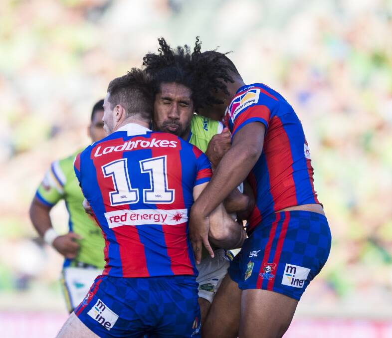 CRUNCH TIME: Canberra's Sia Soliola is wrapped up by Knights forward Lachlan Fitzgibbon and centre Tautau Moga. Picture: Mick Tsikas, AAP