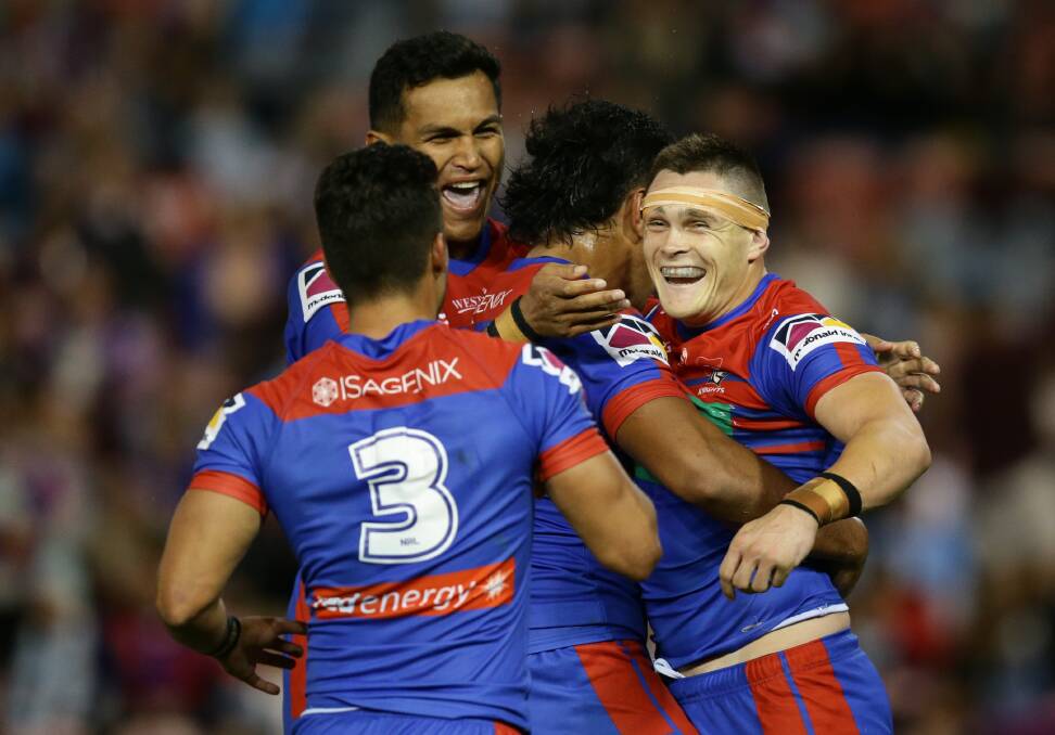 HEART AND SOUL: Newcastle players celebrate with Brodie Jones after scoring a crucial try in the round-six win against Cronulla. Picture: Jonathan Carroll