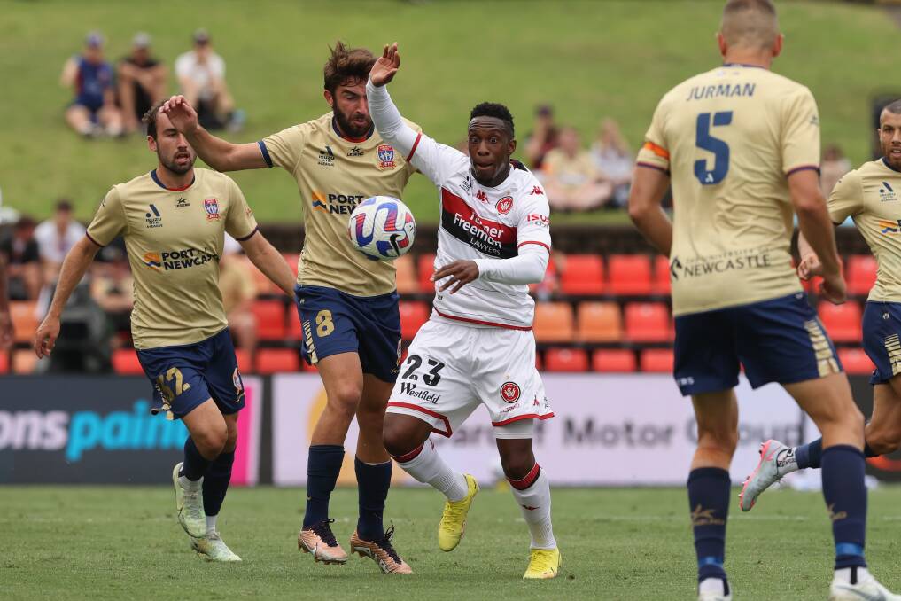 Western Sydney's Yeni Ngbakoto and Newcastle's Beka Dartsmelia battle for the ball at McDonald Jones Stadium on Sunday. Picture by by Ashley Feder, Getty Images