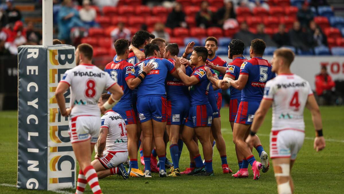 TRY TIME: The Knights celebrate as the scoreline mounts against the Dragons on Sunday. Picture: Marina Neil