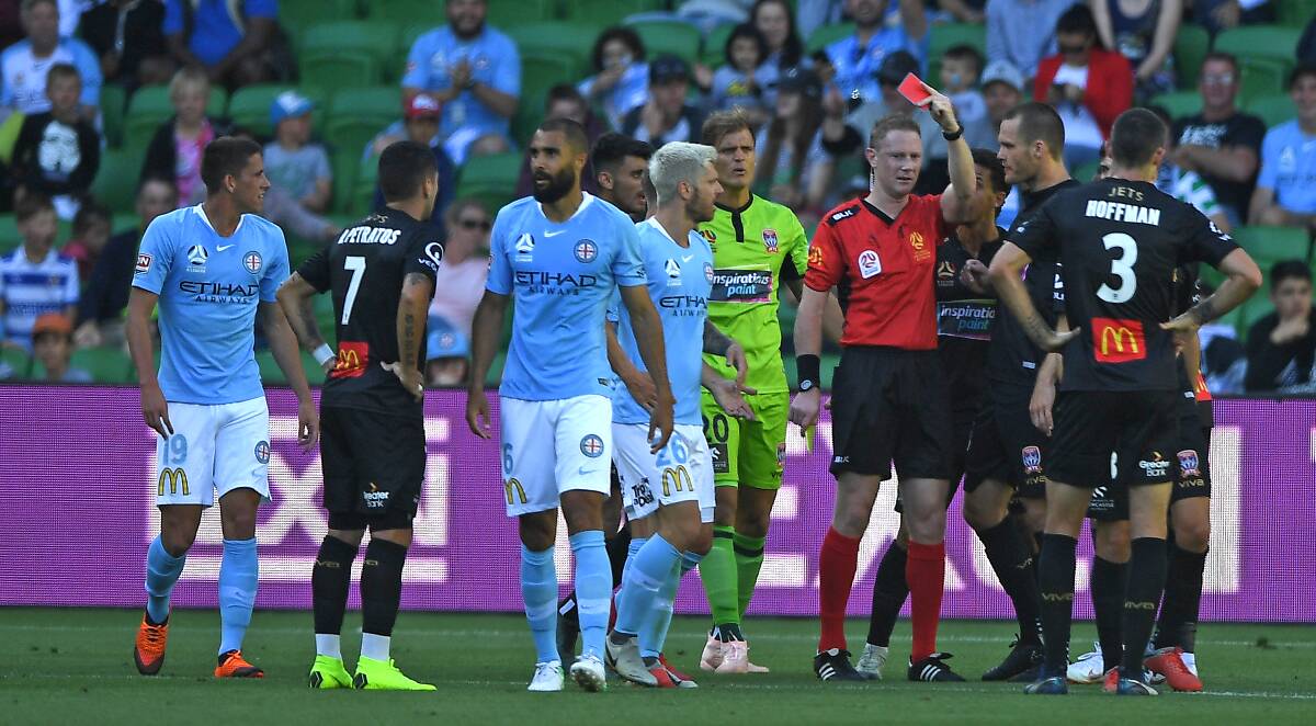 TELL YOUR STORY WALKING: Newcastle's Ronny Vargas receives a red card from referee Kurt Ams in last week's 2-1 loss to Melbourne City. Picture: AAP