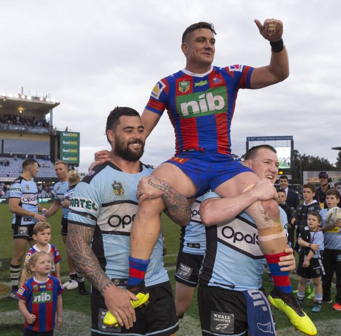 OLD MATES' ACT: Former teammates Andrew Fifita and Paul Gallen chair Chris Heighington off the field at Shark Park last weekend. Picture: AAP