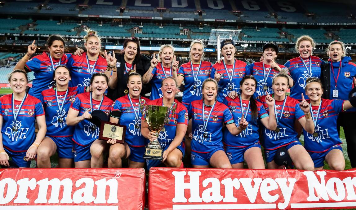 SPOILS OF VICTORY: Skipper Bec Young and teammates with the premiership trophy. Picture: NRL Photos