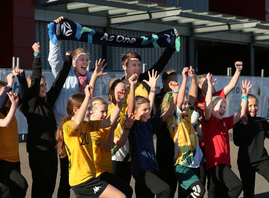 As ONE: Matildas legends Cheryl Salisbury and Joey Peters with young fans on Friday. Picture: Simone De Peak