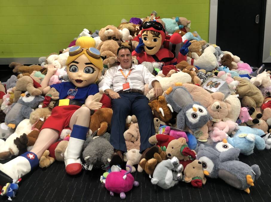 SUCCESS: Jets CEO Lawrie McKinna and club mascots Jets Man and Jet Girl with some of the 1414 teddy bears that were donated on Sunday. 