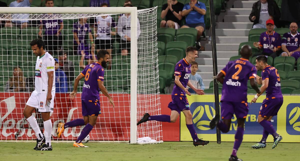 LOSING FEELING: Teenager Ciaran Bramwell (centre) celebrates after opening Perth's account in the 2-1 win over the Jets at HBF Stadium on Saturday night. Picture: Getty Images