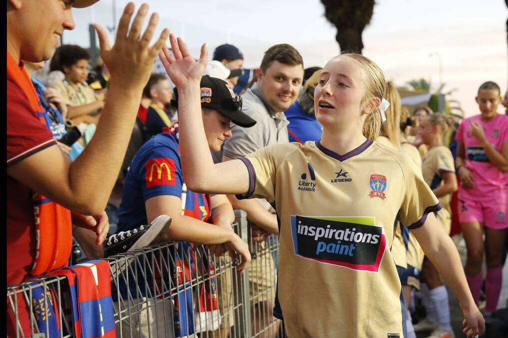 Sixteen-year-old debutant Emma Dundas celebrates with fans after the Jets' 1-0 win. Picture by Darren Pateman, AAP