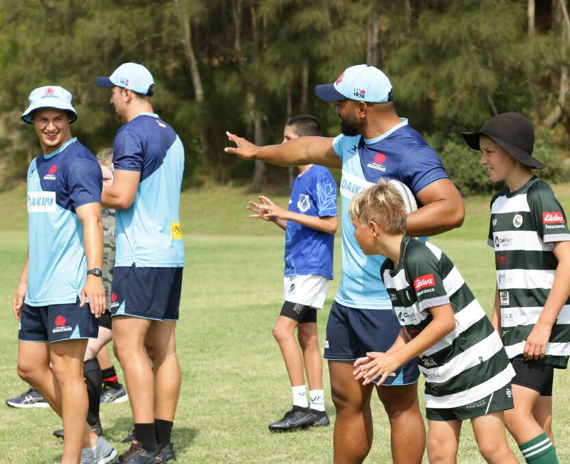 SUPER SESSION: NSW Waratahs Michael McDonald (left), James Ramm and Chris Talakai work with Hunter juniors at a coaching clinic on Tuesday. Picture: Simone De Peak