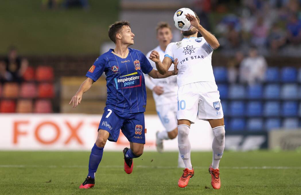 ON THE BALL: Jordan O'Doherty closes in on Sydney FC midfielder Milos Ninkovic in the 1-all draw at McDonald Jones Stadium on Saturday night. Picture: Ashley Feder