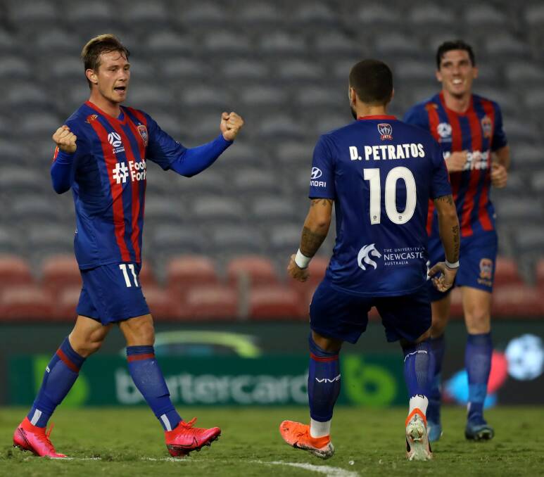 ON TARGET: Nick Fitzgerald celebrates after putting the Jets ahead with a brilliant goal in the 2-1 win over Melbourne City at McDonald Jones Stadium on Monday night Picture: Getty Images 