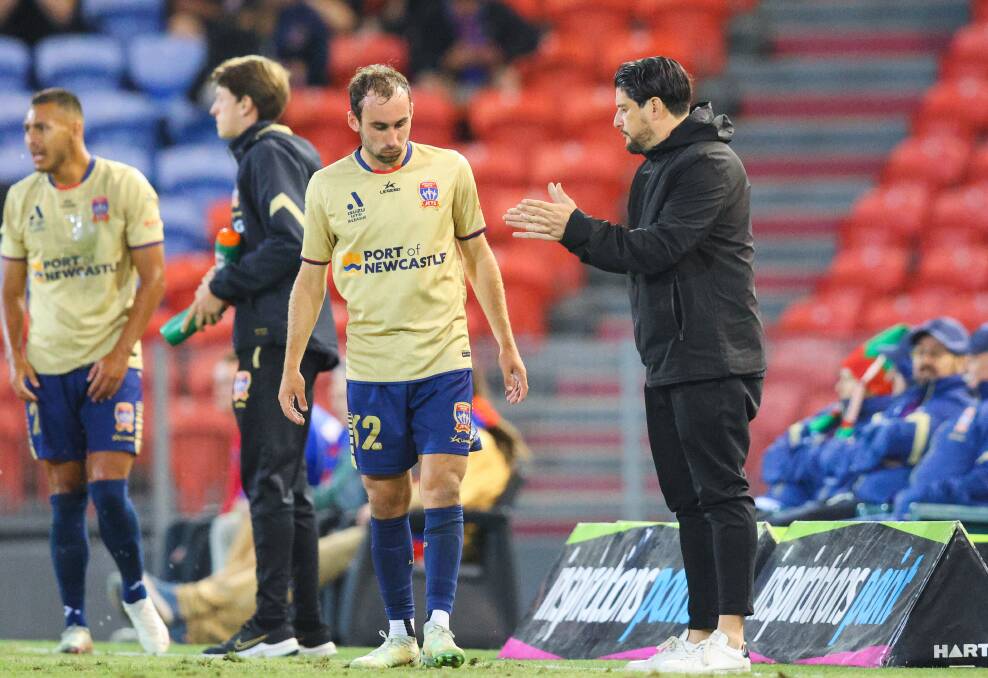 Newcastle Jets coach Arthur Papas makes a point to midfielder Angus Thurgate in the 1-0 loss to Brisbane on Friday night. Picture by Max Mason-Hubers