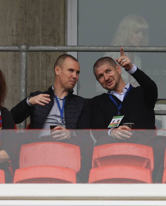 OLD FIRN: Kenny Miller and Carl Robinson in the stands at McDonald Jones Stadium. Picture: Jonathan Carroll