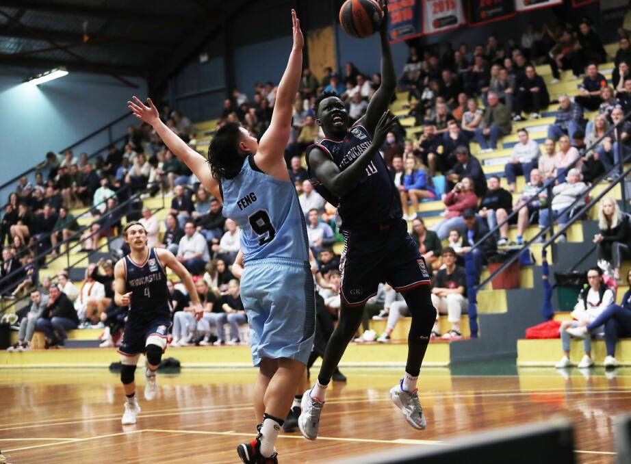 SPARK: Matur Maluach takes the ball to the hoop in the Falcons' 96-78 loss to Sutherland at Broadmeadow Basketball Stadium on Saturday night. Picture: Peter Lorimer 