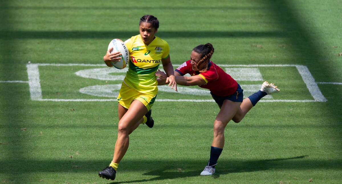 FLYER: Australian sevens star Faith Nathan brushes off a Spanish defender at the world series event in Dubai. Picture: Getty Images