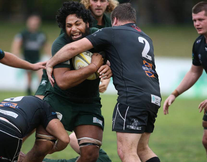 WRAPPED UP: Merewether breakaway Jarome Wilson is swarmed in a tackle.