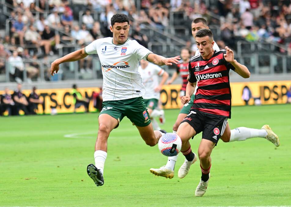 Jets defender Nathan Grimaldi competes with Wanderers winger Alex Badolato for possession. Picture Getty Images