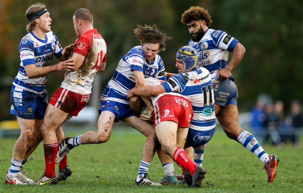 TIGHT SQUEEZE: Central's Kain Anderson (3rd from left) and Dominic Murphy wrap up Souths Newcastle winger Reeve Howard at St John Oval on Sunday.