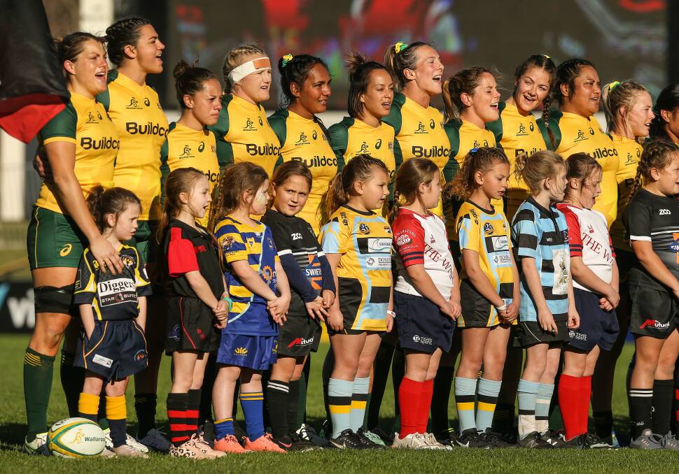 FULL VOICE: The Wallaroos were joined by Hunter junior players to sing the national anthem before taking on Japan at No.2 Sportsground on Saturday. Picture: Marina Neil