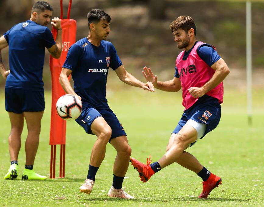 ON DUTY: Johnny Koutroumbis and Ivan Vujica compete for the ball at training. Picture: Marina Neil.