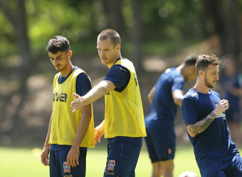 MAKING A POINT: Jets captain Nigel Boogaard gives some direction to defender Johnny Koutroumbis at training on Wednesday. Picture: Jonathan Carroll