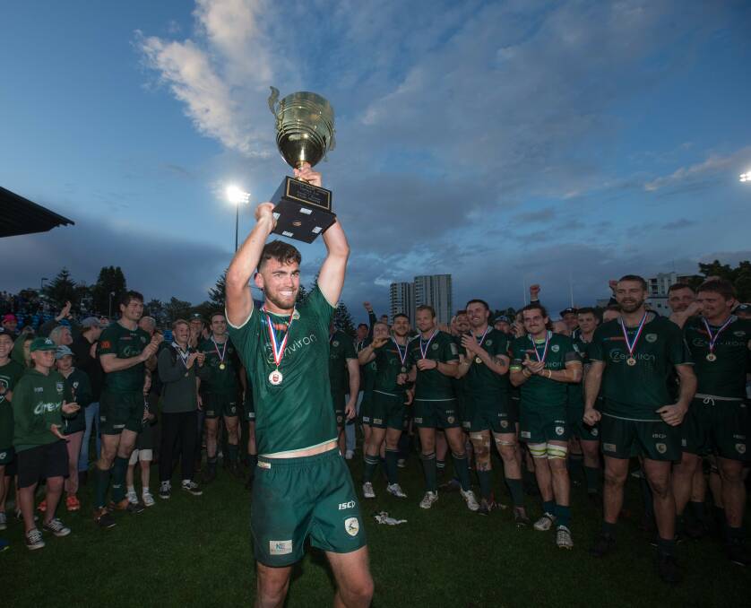 Merewether captain Sam Rouse raises the Tooheys Cup after the Greens' beat Hamilton 19-7 to win their first Hunter Rugby Union premiership since 2011. Picture by Marina Neil