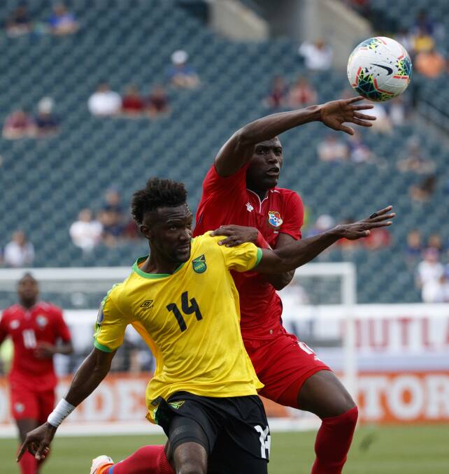 FLYER: Jets recruit and Panama international Abdiel Arroyo competes with Jamaica's Shaun Francis for possession in the CONCACAF Gold Cup quarter-final on Monday. Picture: AP