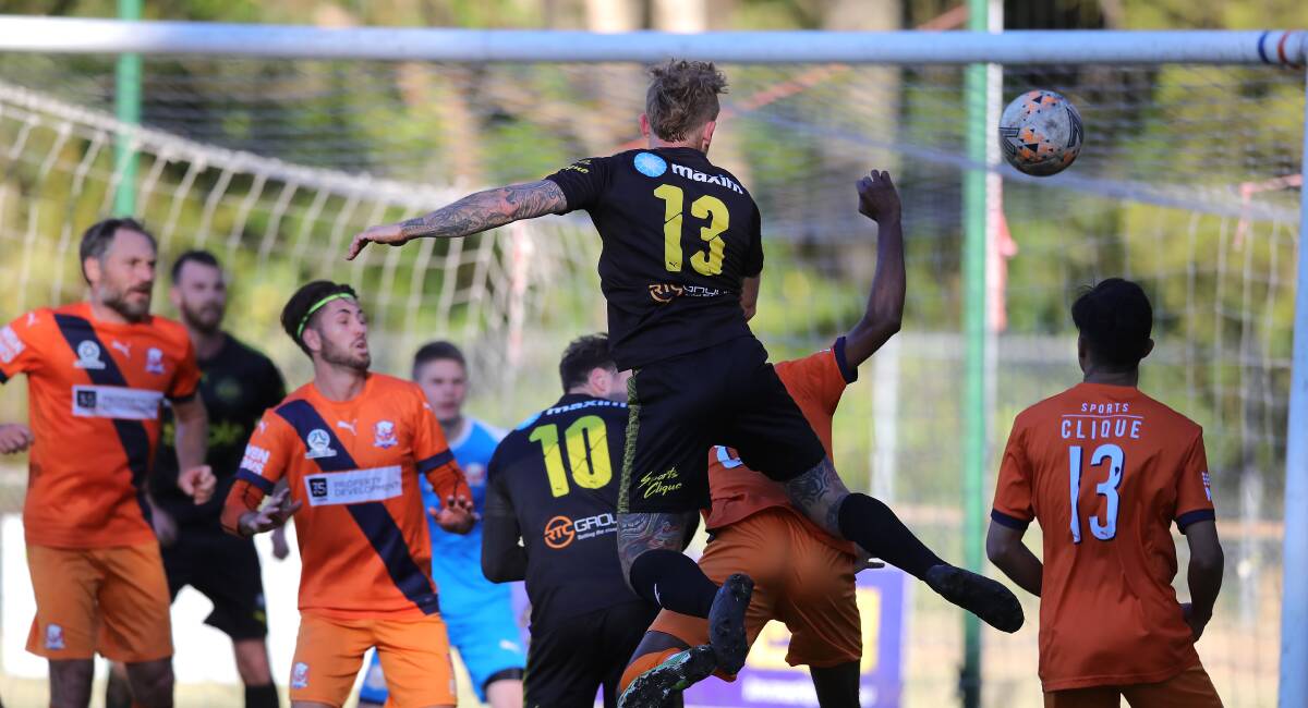TOUGH SLOG: Lambton Jaffas defender connects with a header in the 1-all draw with Valentine Phoenix on Sunday. Picture: Sproule Sports Focus