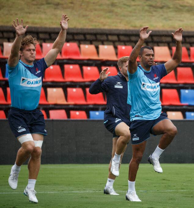 HANDS UP: Waratahs superstars Michael Hooper and Kurtley Beale go through a warm-up at training on Friday. Picture: Max Mason-Hubers