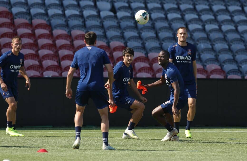 READY FOR TAKE OFF: Newcastle Jets players go through their paces on the newly laid surface at McDonald Jones Stadium ahead of the battle against Adelaide United on Saturday. Picture: Simone De Peak