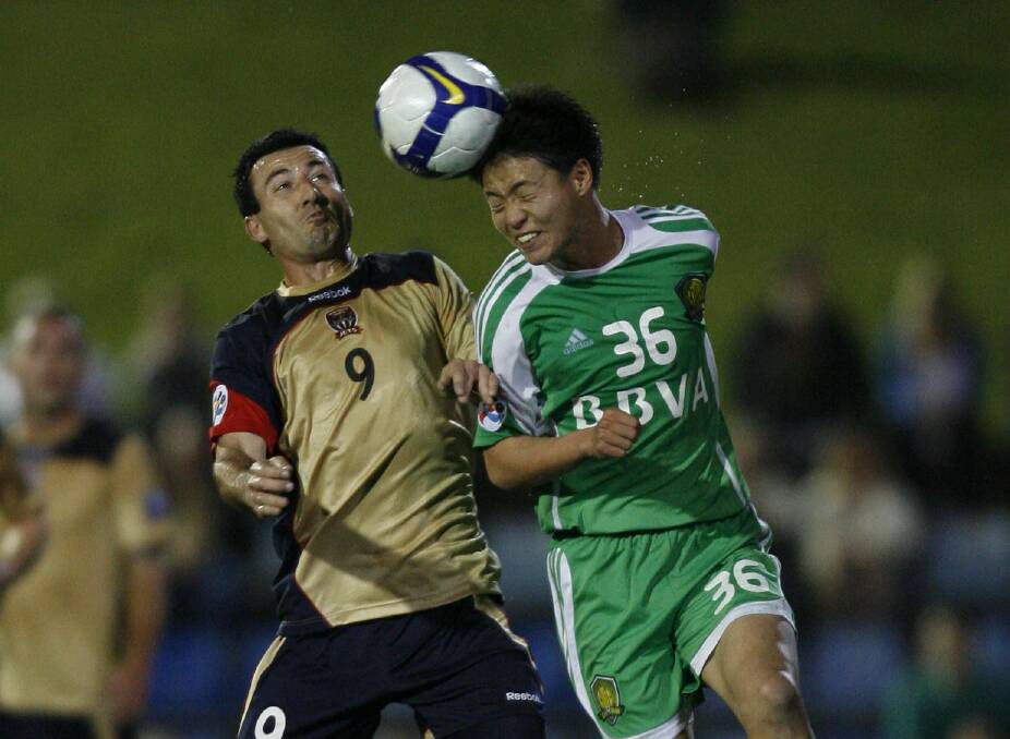 HEAD UP: Striker Sasho Petrovski competes for a header with Beijing Guoan's Zhu Yifan. The Jets made the final 16 of the Asian Champions League.