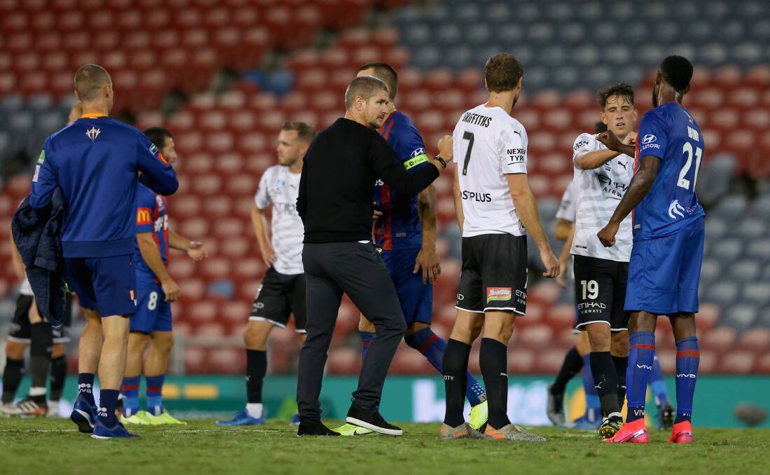 SIGNING OFF: Jets players and staff bump elbows with their opponents after the 2-1 over Melbourne City on Monday night. The A-League has been postponed until April 22 at the earliest. Picture: Getty Images