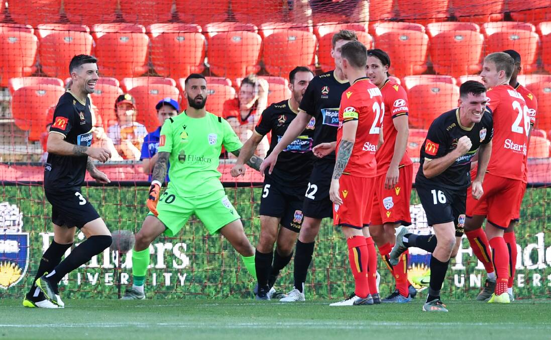 ON TARGET: Fullback Matt Millar pumps his fist after scoring a goal with a well-taken header in the Jets' unlucky 2-1 loss to Adelaide United at Coopers Stadium on Sunday night. Picture: Mark Brake (Getty Images)