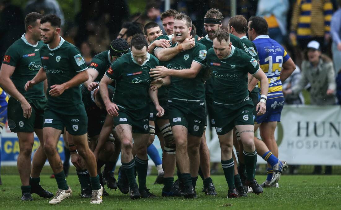 Merewether halfback Eli McCulloch (centre) is congratulated by teammates after scoring a try in the Greens' 19-7 win over Hamilton. Picture by Marina Neil