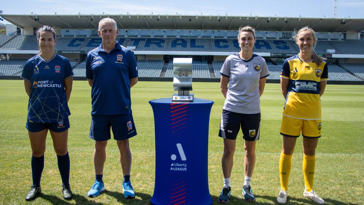 Jets vice captain Alex Huynh coach Gary van Egmond, mariners coach Emily Husband and captain Taren King with the new F3 derby trophy for the women. 