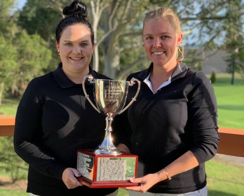 DYNAMIC DUO: Stacie McDonald and Holly Ibbotson with the District Foursomes Championship trophy. 
