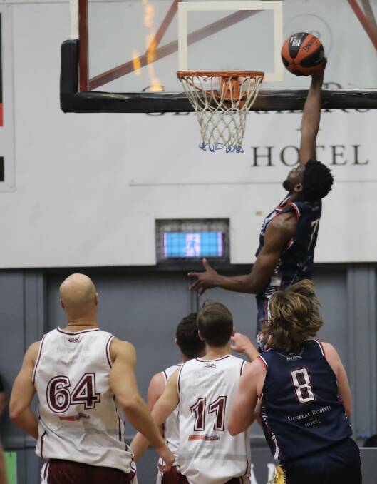 SLAM: Falcon import JaShaun Smith climbs high for a dunk in the win over Manly at Broadmeadow on Saturday night. Picture: Sproule Sports Focus