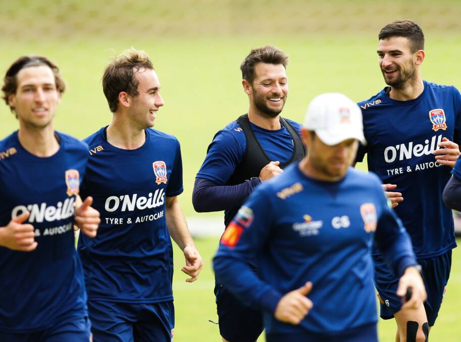 CENTRE STAGE: Wes Hoolahan (third from left) enjoys a laugh with Jets teammates. Picture: Jonathan Carroll