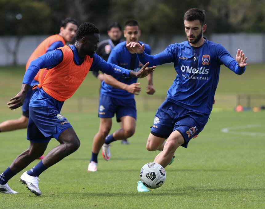 ON THE JOB: Striker Beka Mikeltadze (right) attempts to go past fellow import Olivier Boumal at Jets training this week. Picture: Sproule Sports Focus