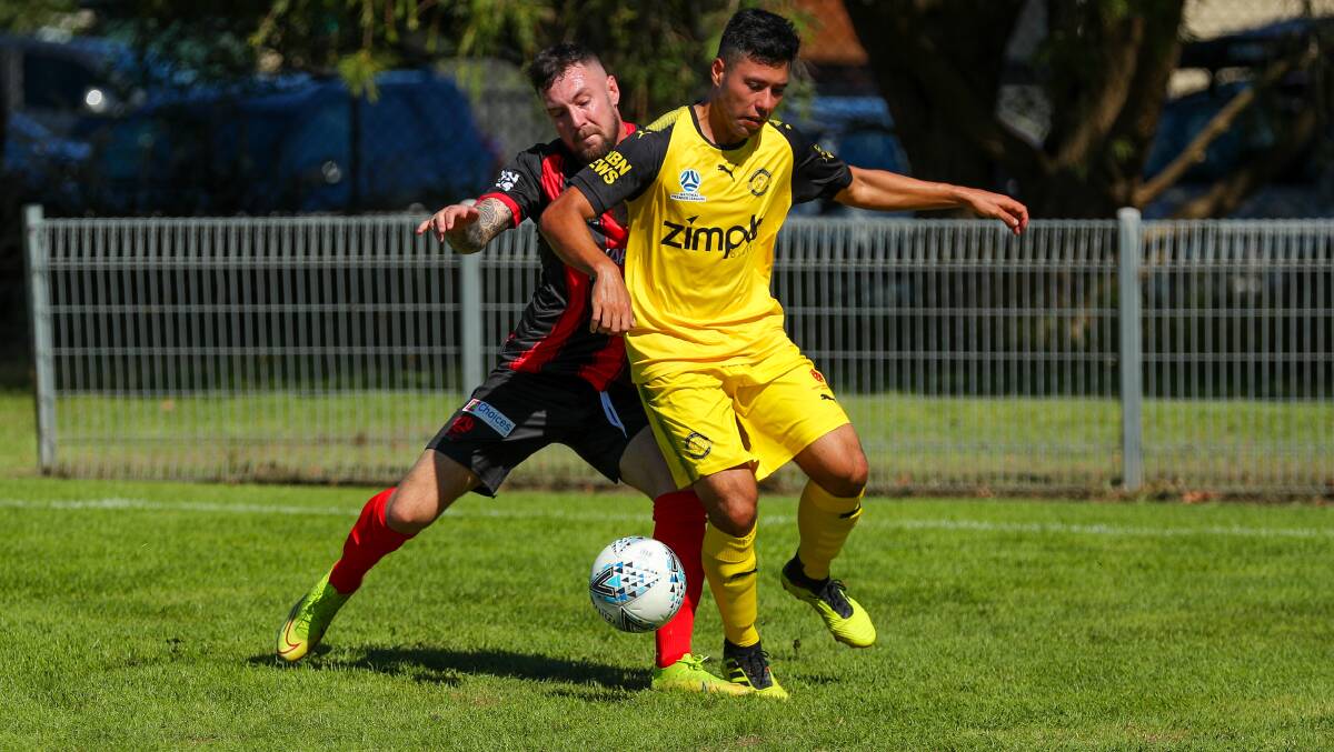 STRONG: Edgeworth striker Jake McGuiness muscles Lambton midfielder Andrew Pawiak off the ball in the Eagles' 2-0 win at Edden Oval on Friday. Picture: Max Mason-Hubers
