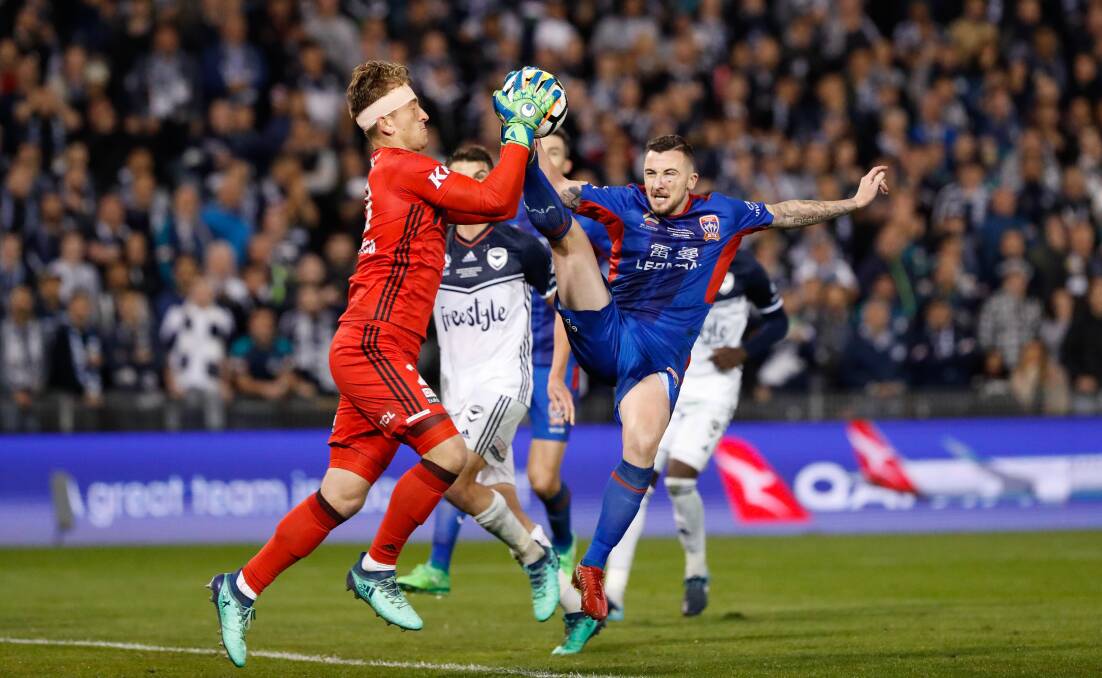 FLASH POINT: Roy O'Dovonan challenges for the ball as Melbourne Victory Lawrence Thomas claims it in the dying moments of the Jets' controversial 1-0 loss. The striker collected the keeper with his boot and was suspended for 10 weeks. Picture: Darren Pateman