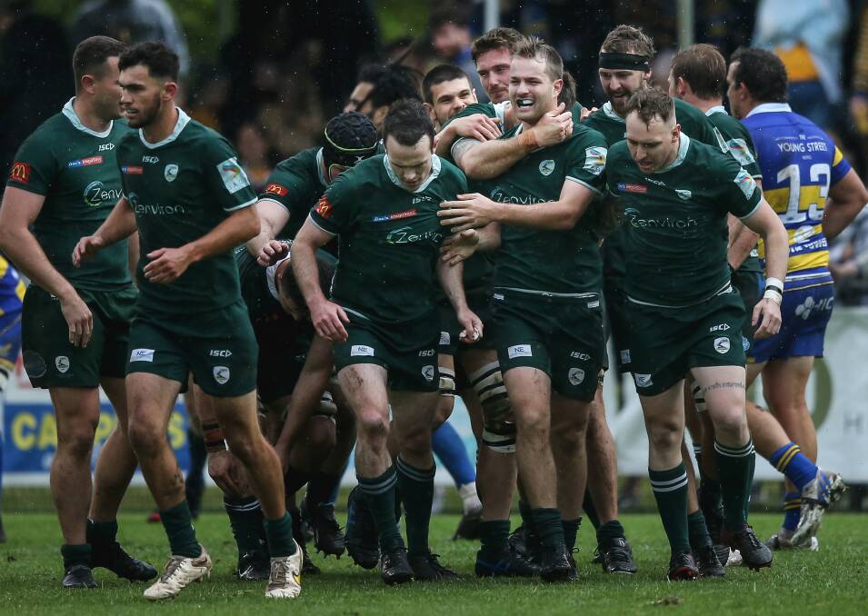 Merewether teammates congratulate halfback Eli McCulloch after scoring in the Greens' win over Hamilton in the grand final. Picture by Marina Neil 