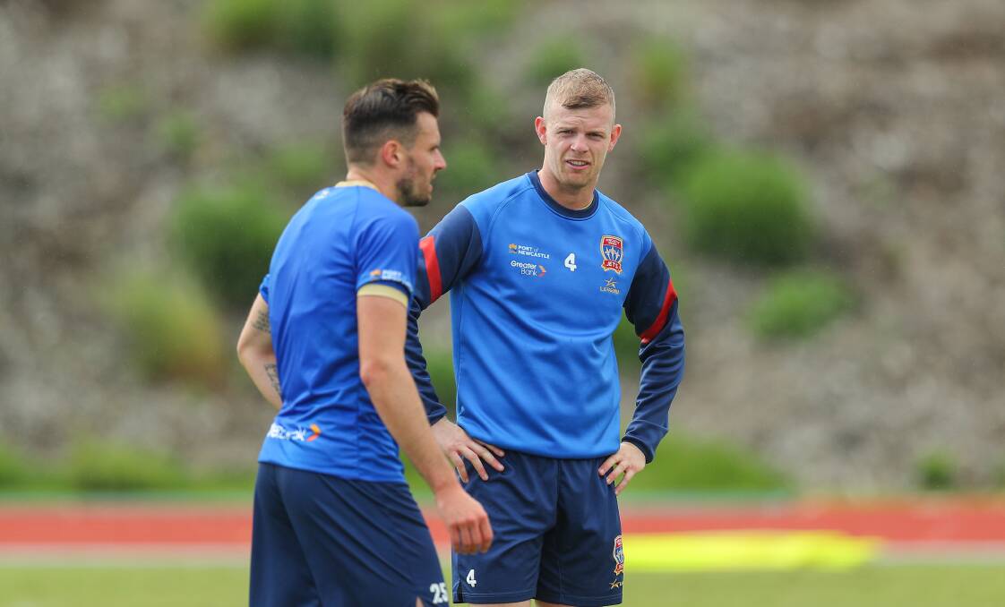 Jordan Elsey and Carl Jenkinson at Jets training on Monday. The defender is excited for the Jets' belated start to the season. Picture by Max Mason-Hubers