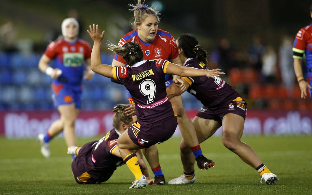 Newcastle Knights prop Caitlan Johnston knocks Brisbane defenders flying. Johnston will be out to set the tone for the Knights in Sunday's NRLW grand final. Picture by Darren Pateman