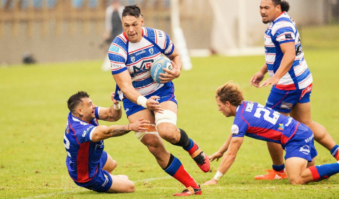 Ngarhue Jones powers through two defenders in the Hunter Wildfires' 27-19 win over Manly on Saturday. The Wildfires host Randwick at No.2 Sportsground on Good Friday. Picture by Stewart Hazell