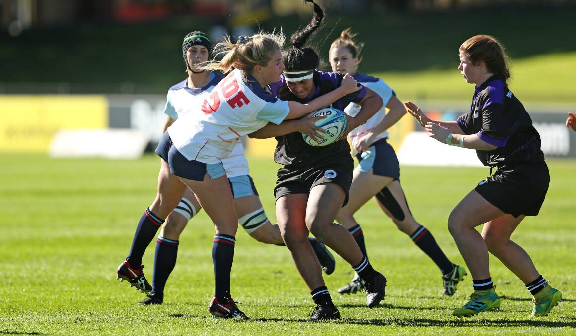 TOUGH TASK: Newcastle's Sammy McCarthur attempts a tackle in Australian Defence Force's 41-0 loss to their New Zealand counterparts at No.2 Sportsground on Saturday. Picture: Marina Neil