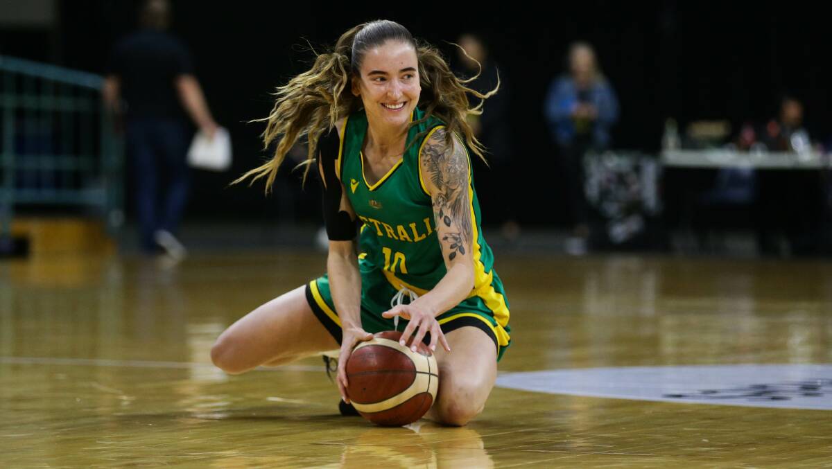 HUSTLE: Anelli Maley drags in a loose ball during the Opals loss to Japan on Tuesday night. Picture: Jonathan Carroll