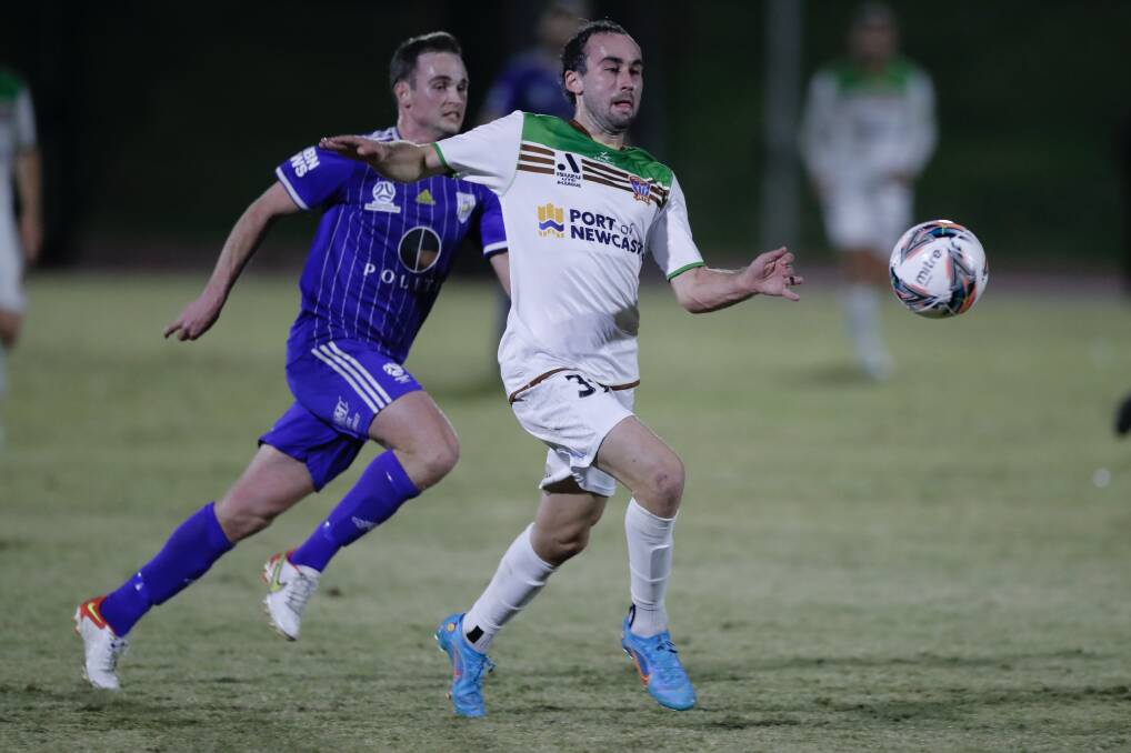 ON THE BALL: Jets midfielder Angus Thurgate powers away from Blake Green in the friendly against Newcastle Olympic on Wednesday night. Picture: Jets media (SSF)